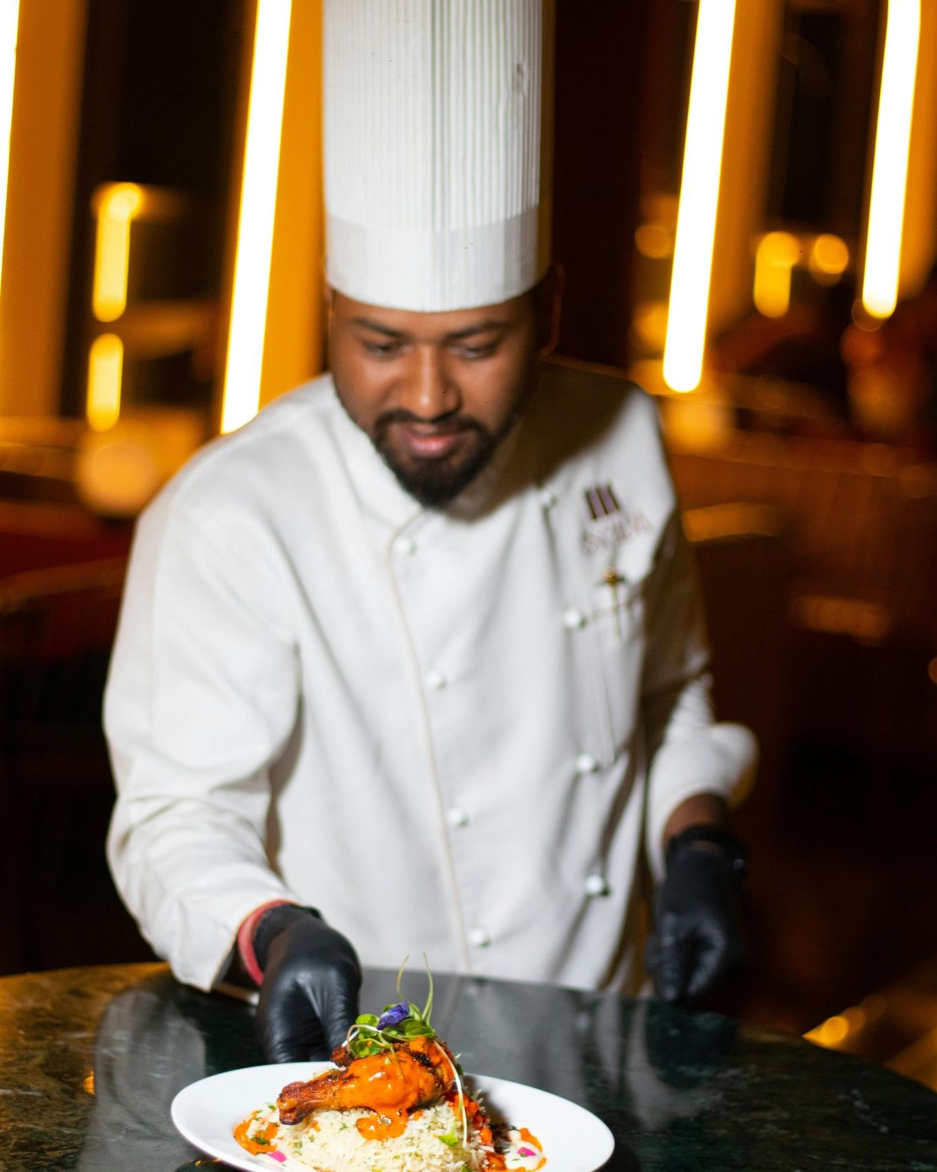 Chef Marco carefully plating a signature dish in the kitchen